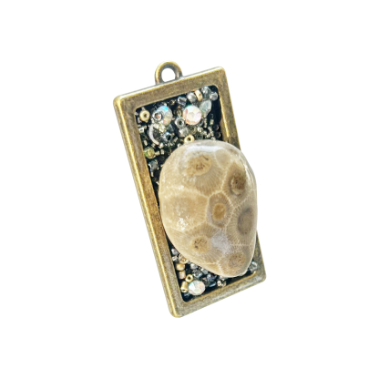Angled photo of the Lake Michigan Petoskey Stone pendant, showing its textured stone surface and sparkling accents.