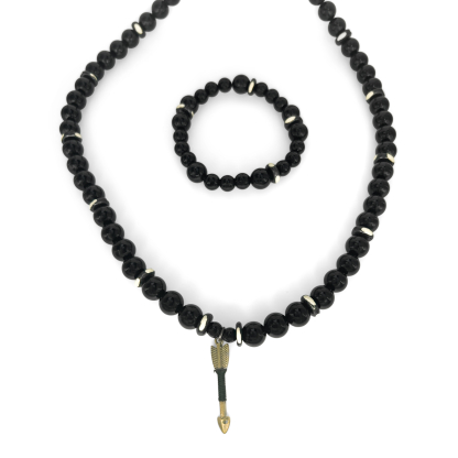 “Black Onyx necklace and bracelet set with arrow charm and white earth beads on white background.”