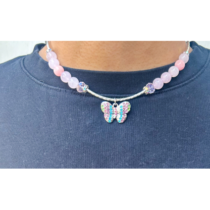 Lifestyle photo of a Rose Quartz Butterfly Necklace worn on a model, featuring a colorful butterfly charm at the center.